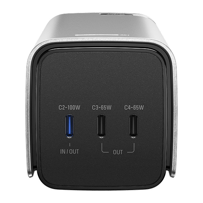 Vista frontale di un caricatore USB-C argento e nero con tre porte etichettate IN/OUT e OUT.