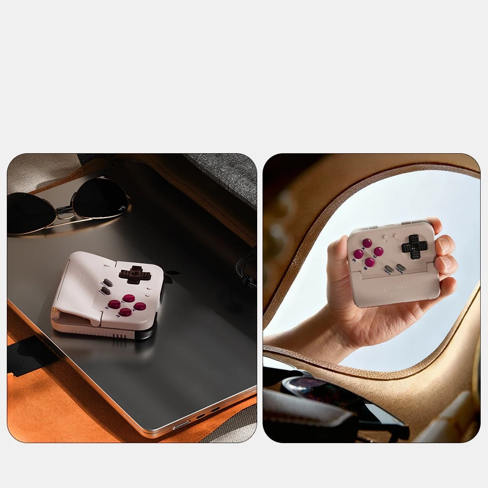 Ręka trzyma kompaktową, białą konsolę do gier retro, a druga spoczywa na laptopie.