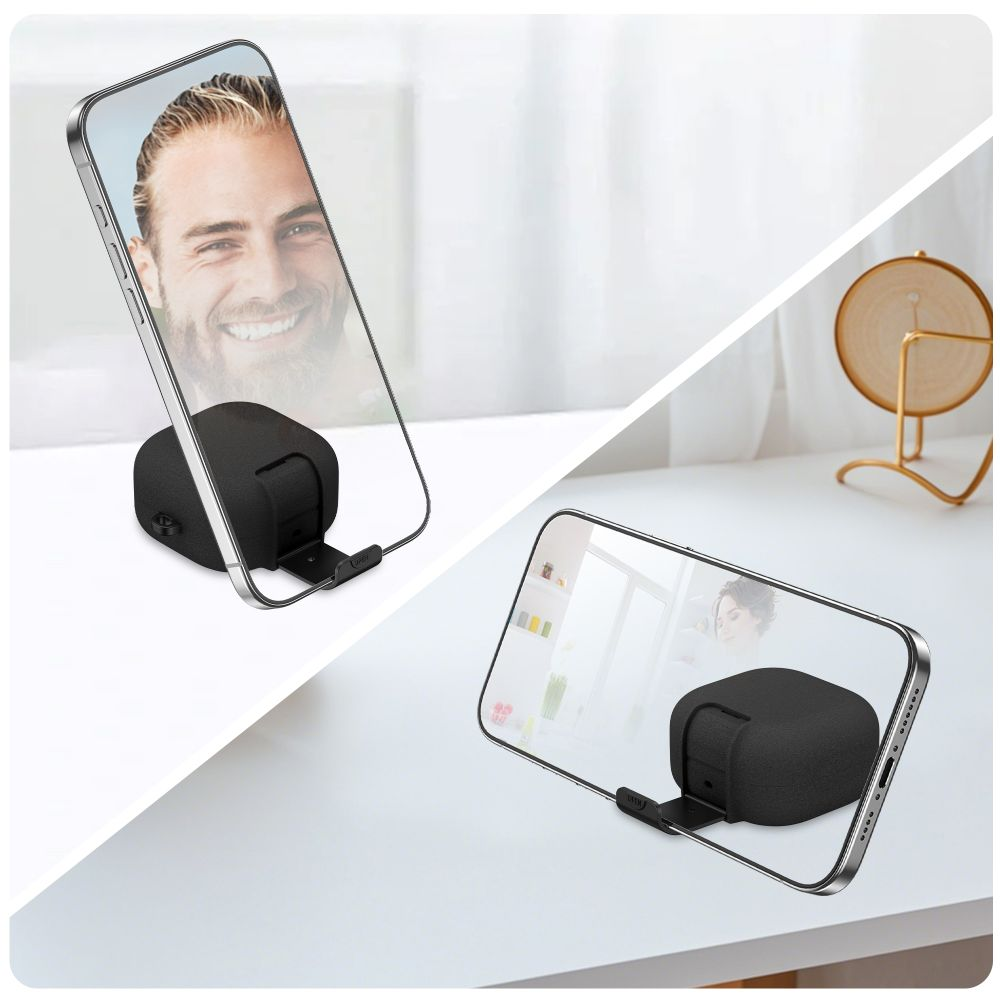 Ein Smartphone auf einem kleinen schwarzen Ständer auf einem weißen Tisch.