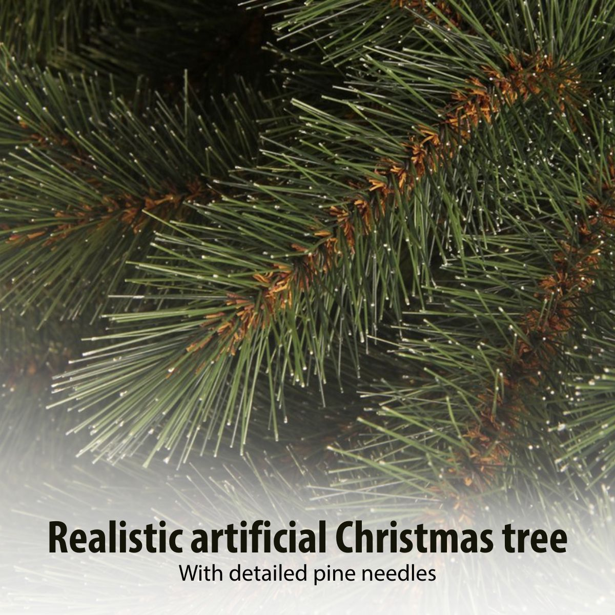 Close-up of a realistic artificial Christmas tree showing detailed green needles and brown branches.