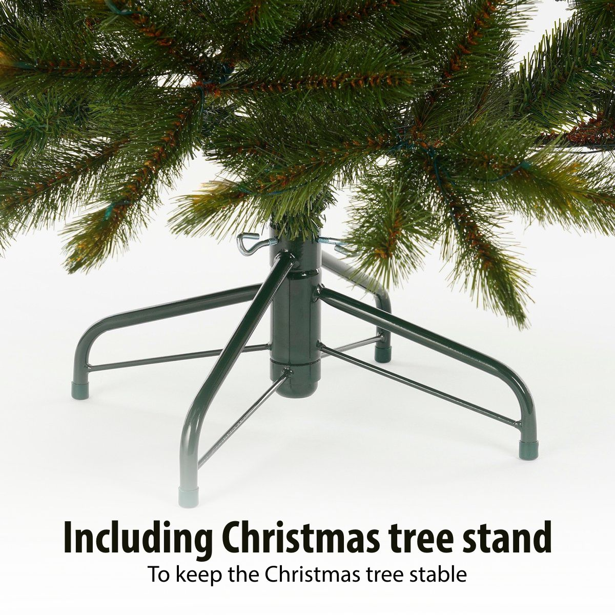 Green Christmas tree in a sturdy green metal stand against a white background.