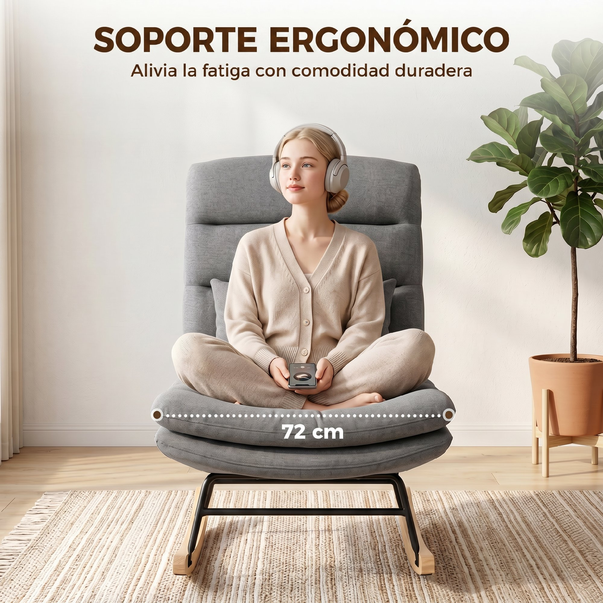 Una mujer con auriculares y un móvil se sienta en una mecedora gris ergonómica.