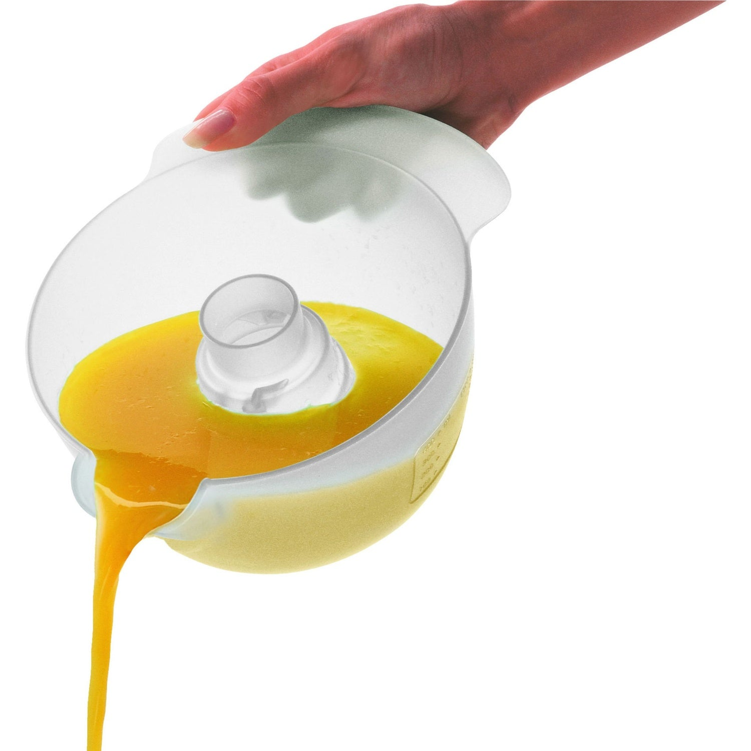 Una mano vierte líquido amarillo de un bol de plástico blanco con un cilindro central.