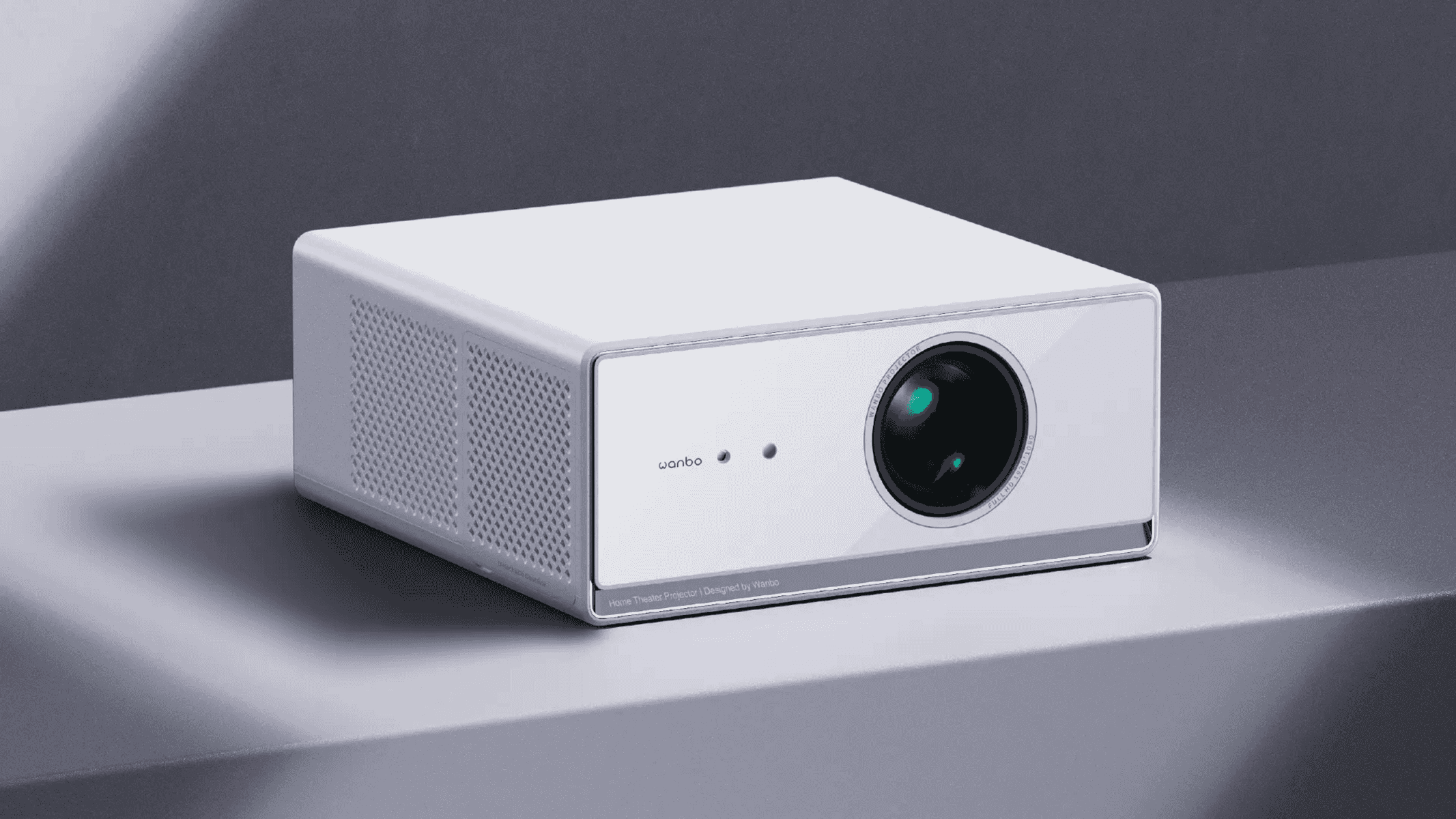 Un proiettore home theater Wanbo bianco su una superficie grigia con sfondo neutro.