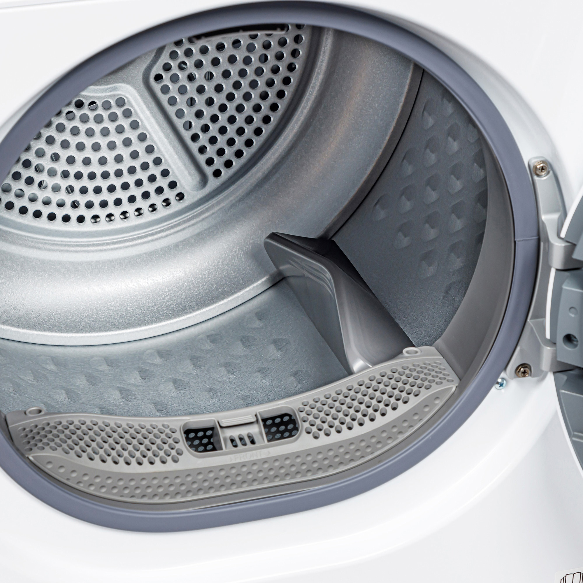 The open interior of a modern white clothes dryer with a perforated stainless steel drum and a gray lint filter.