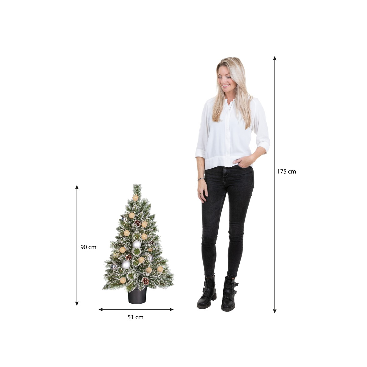Een vrouw in een witte blouse staat naast een kerstboom van 90 cm op een witte achtergrond.