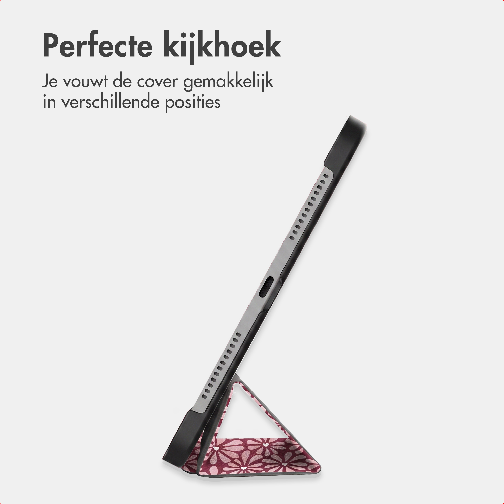 Une tablette dans une housse de protection pliante à motif floral servant de support.