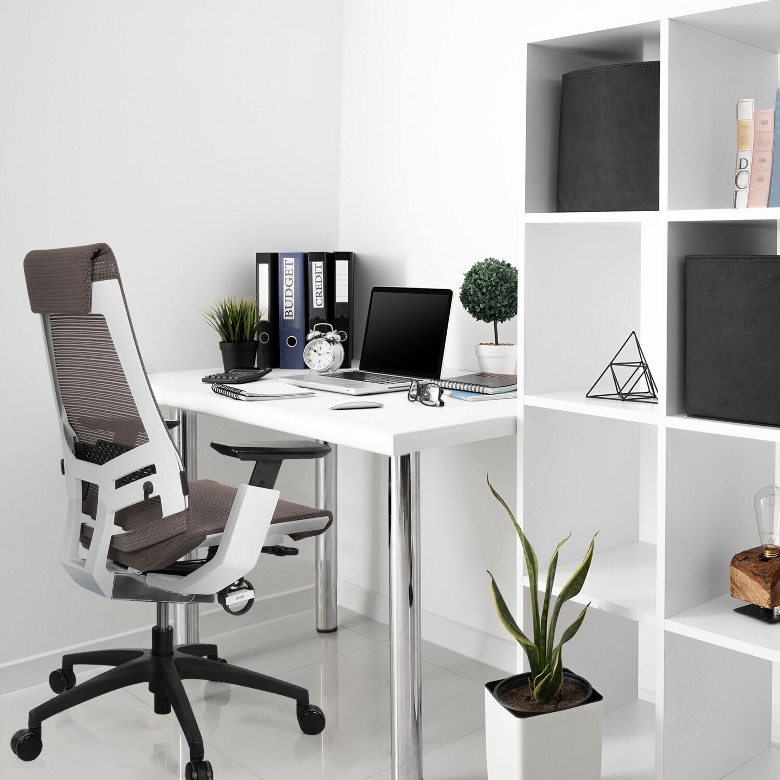 Moderne Büro-Ecke mit weißem Schreibtisch, grauem Stuhl, Laptop und Regal.
