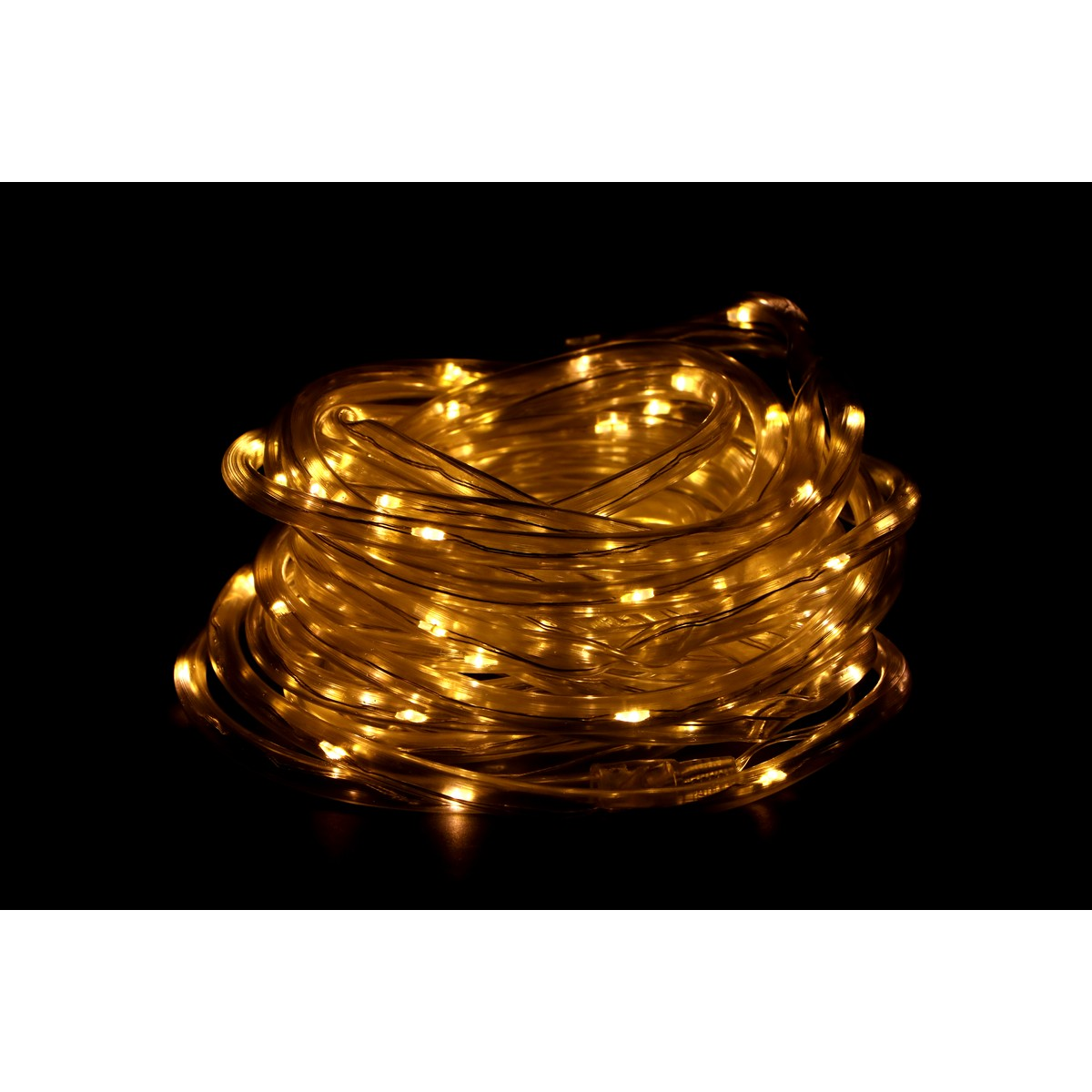 A coil of warm white glowing LED fairy lights against a black background.