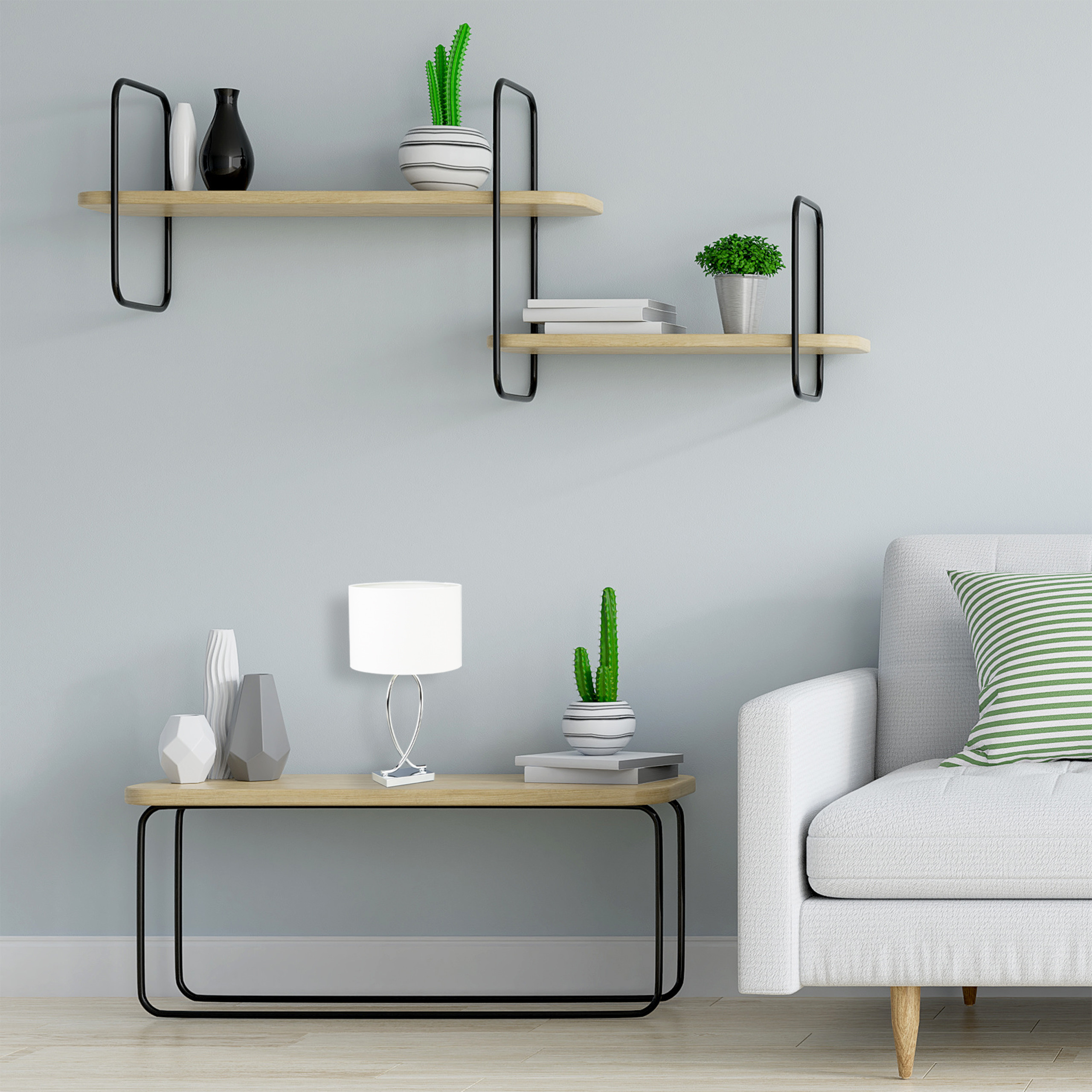 Ein Wohnzimmer mit grauem Sofa, Holztisch mit Lampe und Kaktus sowie Regalen mit Dekoration.