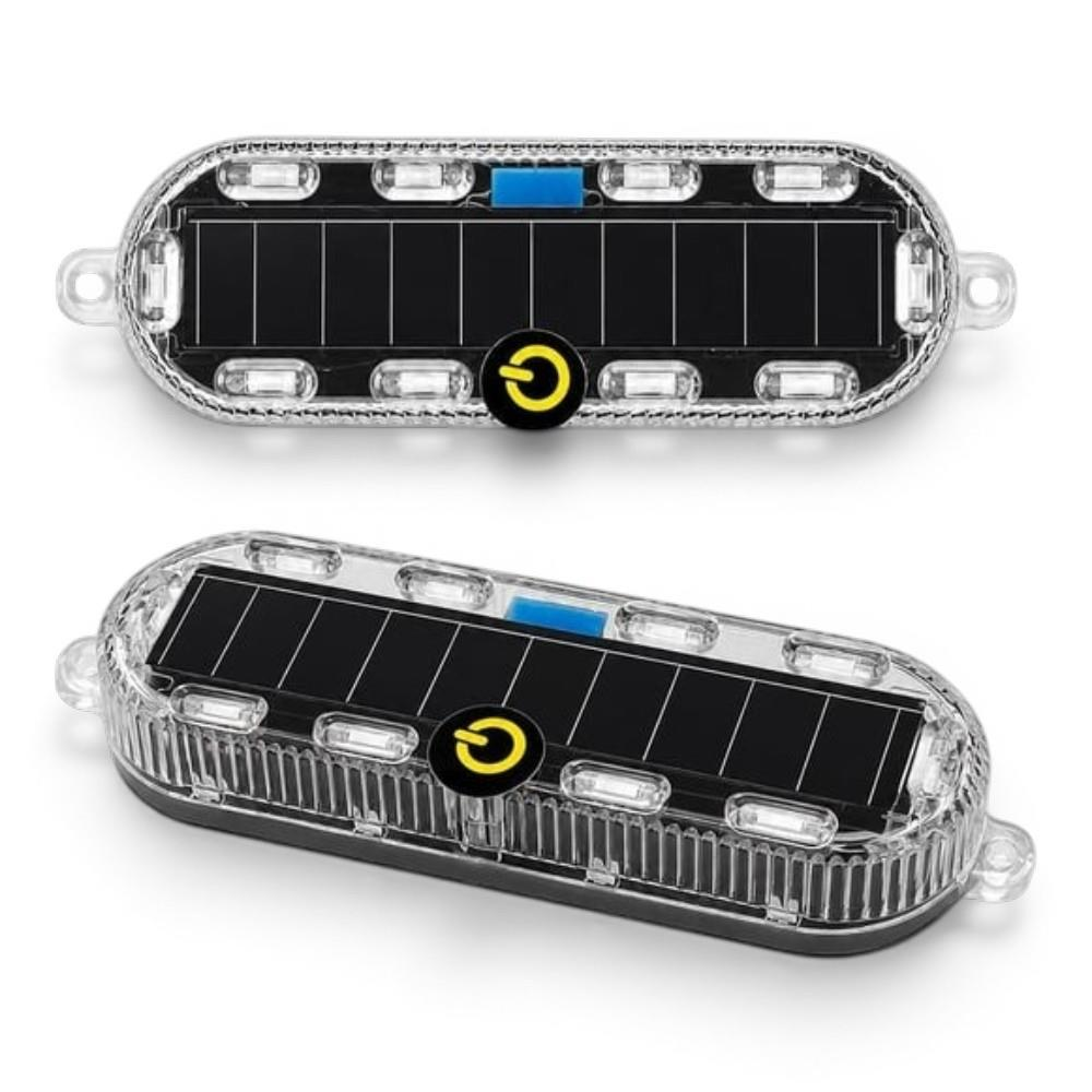 Beyaz arka planda güneş paneli ve sarı güç düğmesine sahip iki oval şeffaf güneş enerjili LED lamba.