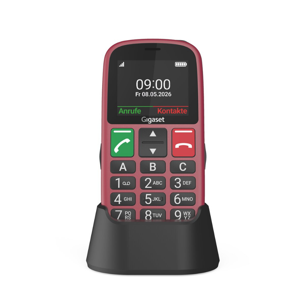 Ein rotes Handy mit großen Tasten und einer schwarzen Ladeschale vor weißem Hintergrund.