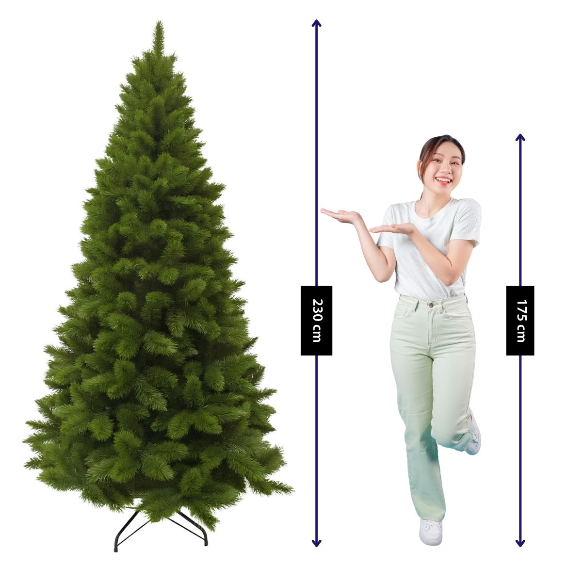 Une femme désigne un sapin de Noël vert de 230 cm à côté d'elle.