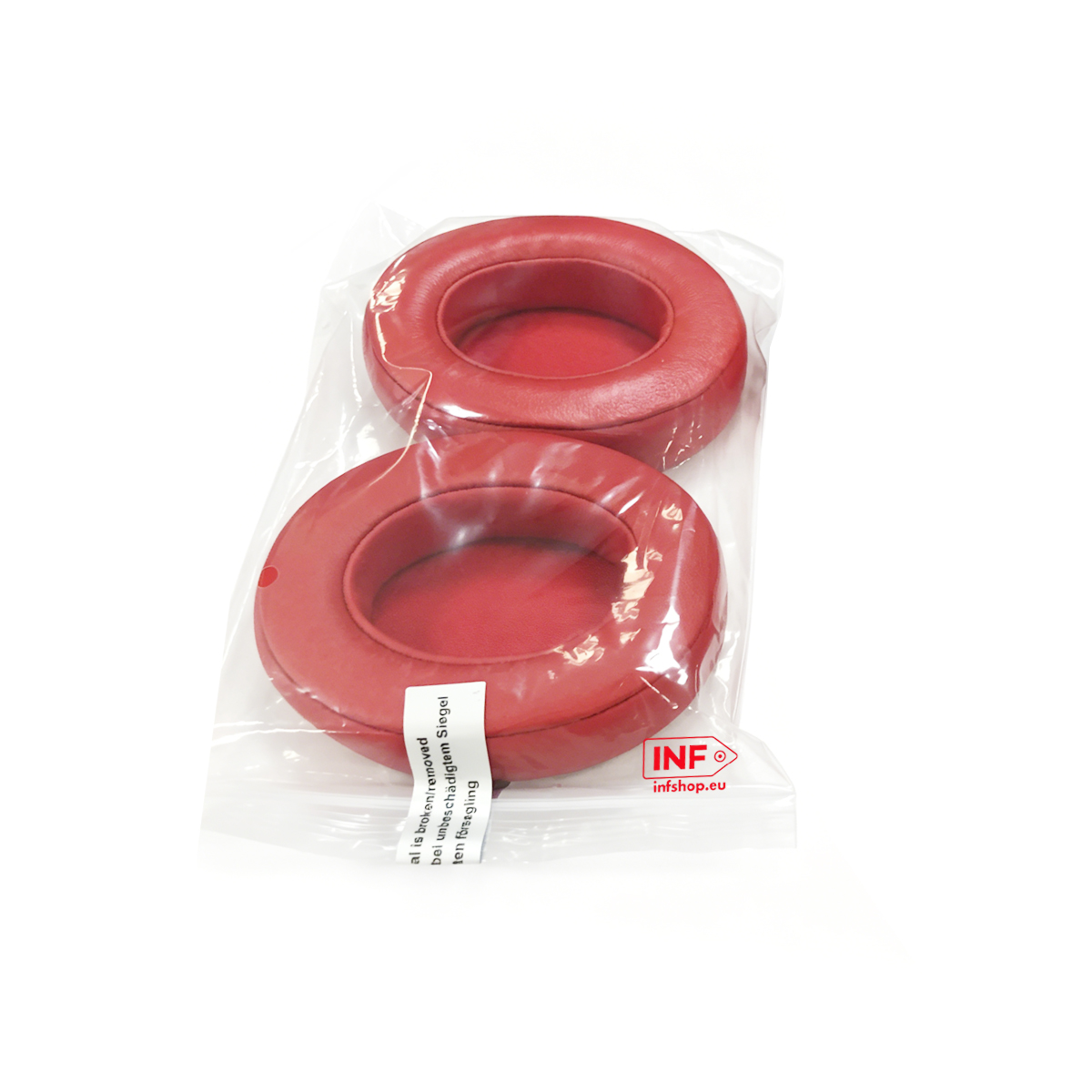 Zwei rote Kopfhörer-Otoplastiken in einer Plastiktüte mit Aufkleber.