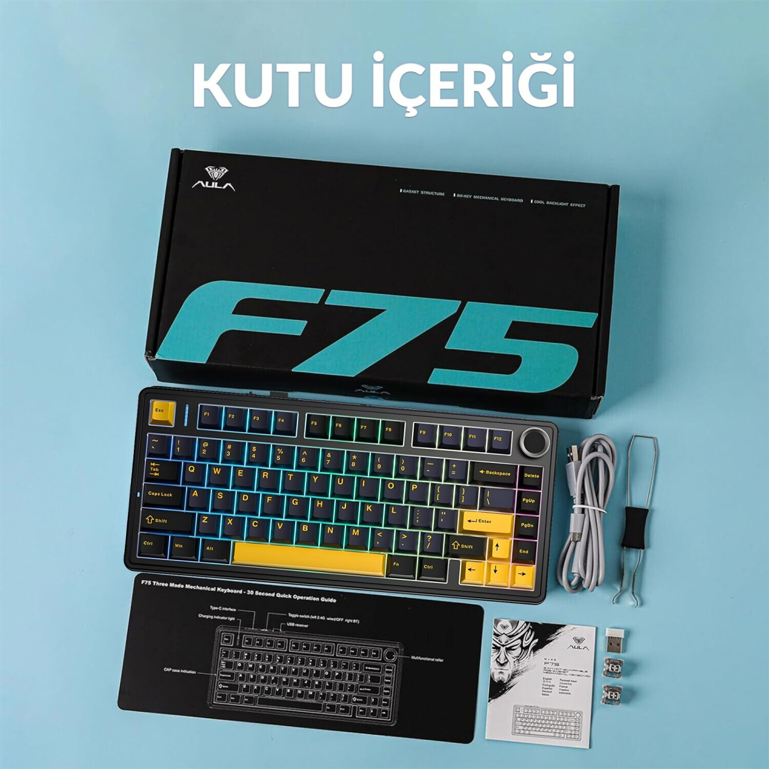 Mavi zemin üzerinde aksesuarları, kutusu ve kılavuzu ile AULA F75 mekanik klavye.