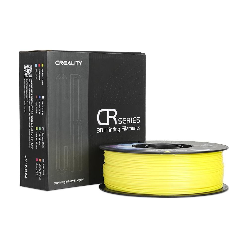 Una bobina de filamento de impresin 3D amarillo se encuentra frente a una caja negra de Creality.
