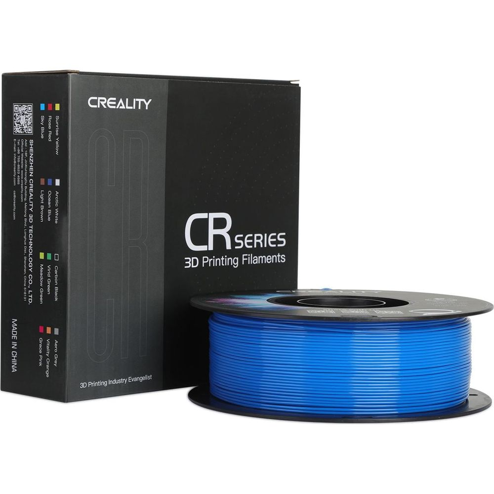 Una scatola nera per filamenti di stampa 3D Creality CR Series accanto a una bobina di filamento blu.