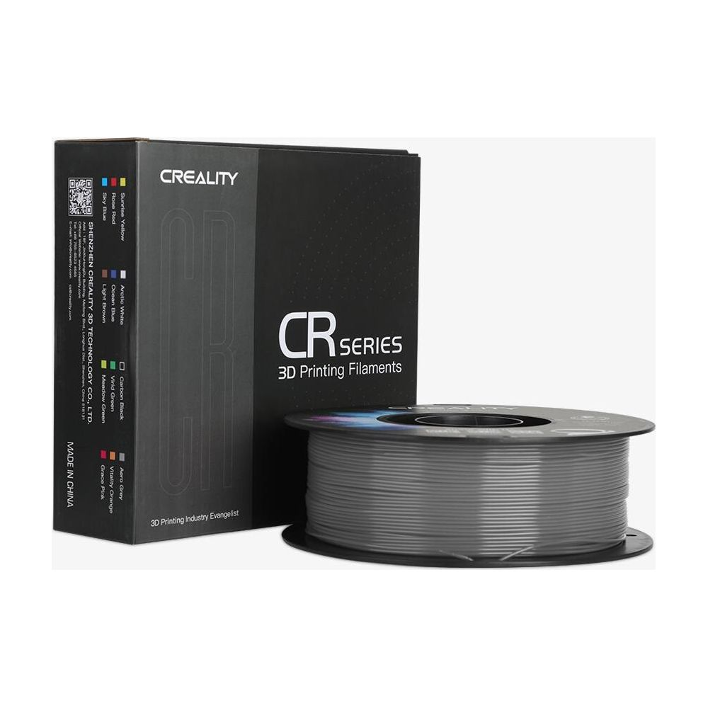 Una scatola nera e una bobina di filamento per stampa 3D grigio di Creality.