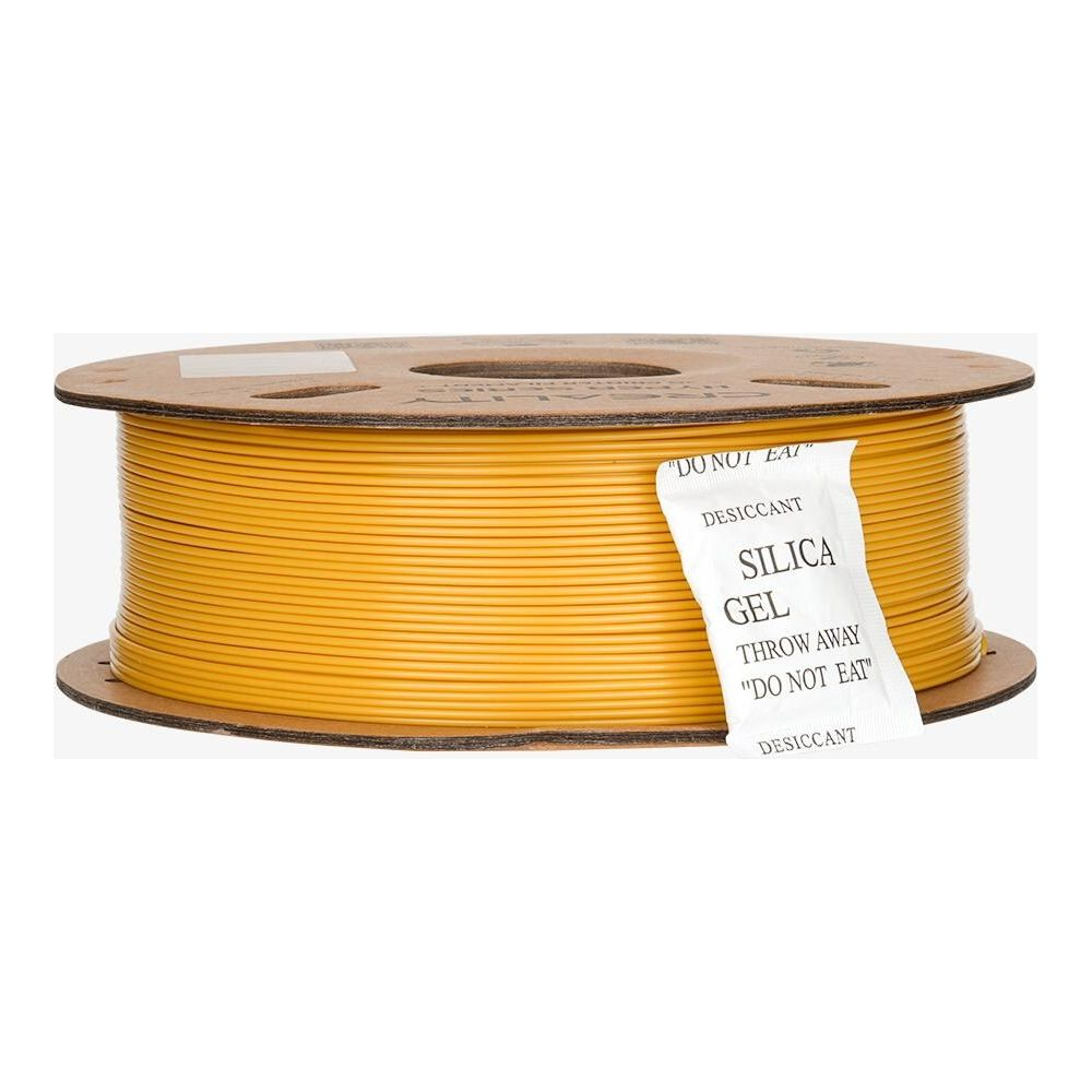 Una bobina di filamento giallo per stampante 3D con un pacchetto di gel di silice.