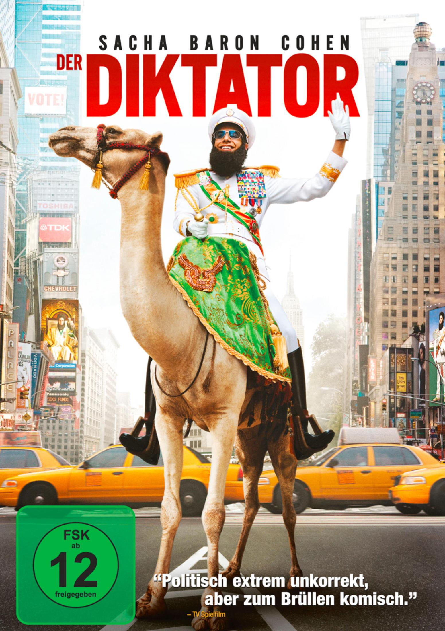 Sacha Baron Cohen reitet als Diktator auf einem Kamel durch New York vor gelben Taxis.
