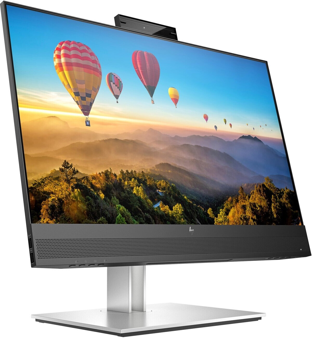 Nowoczesny monitor HP z kamerą wyświetla kolorowe balony na ogrzane powietrze nad górzystym krajobrazem.