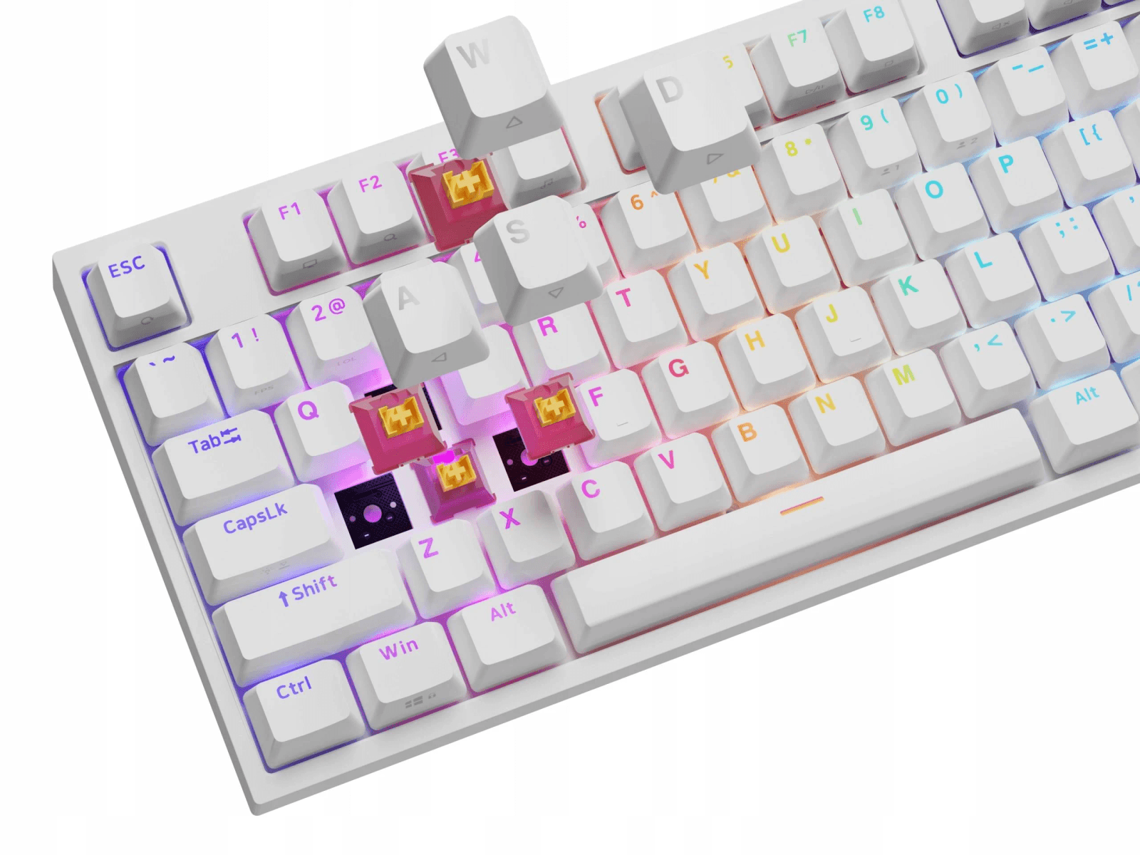 Un teclado mecánico blanco con teclas WASD quitadas e interruptores rosas.