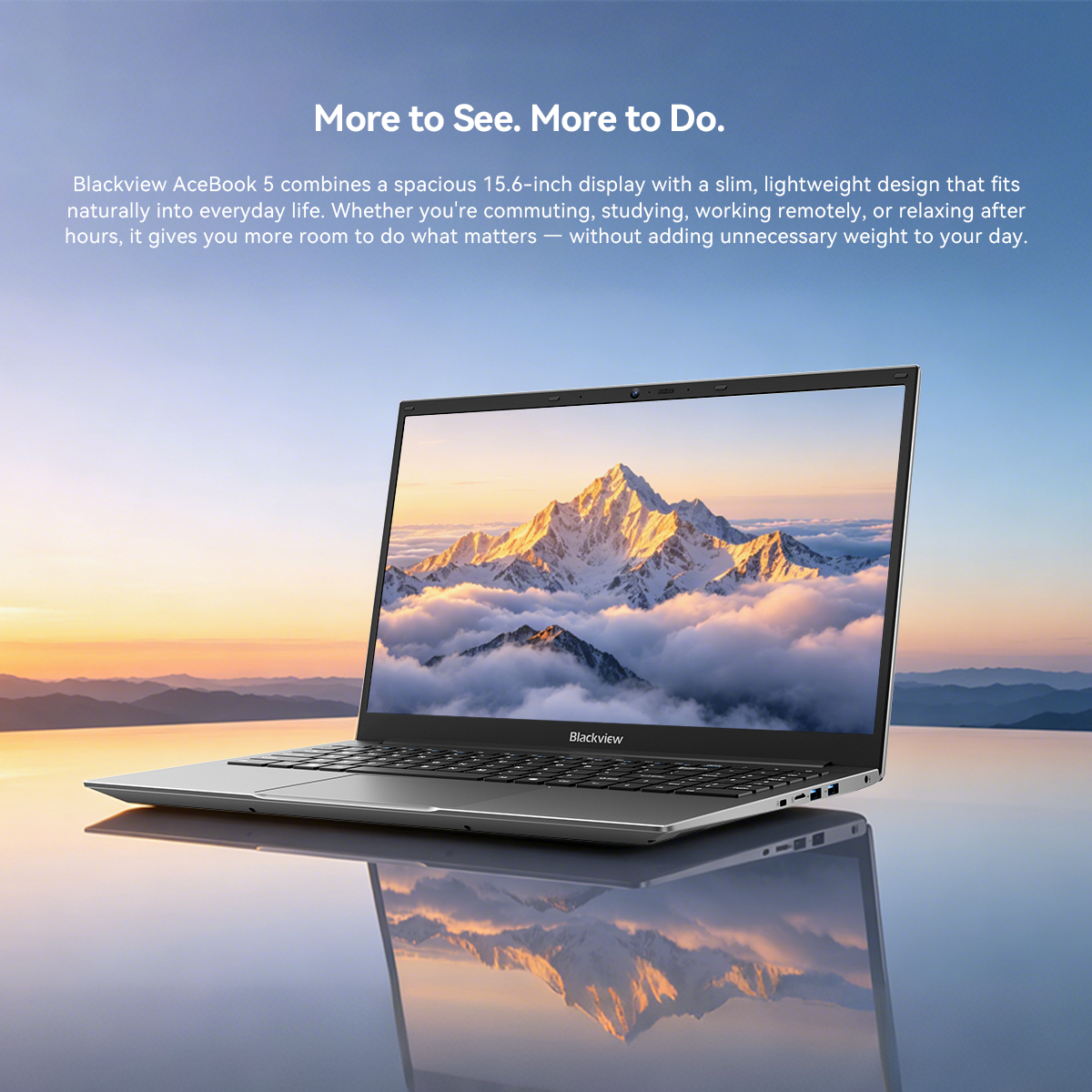 A Blackview AceBook 5 laptop on a reflective surface against a mountain landscape at sunset.