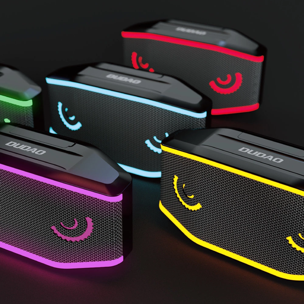 Molti altoparlanti Bluetooth Dudao neri con luci LED colorate su un tavolo.