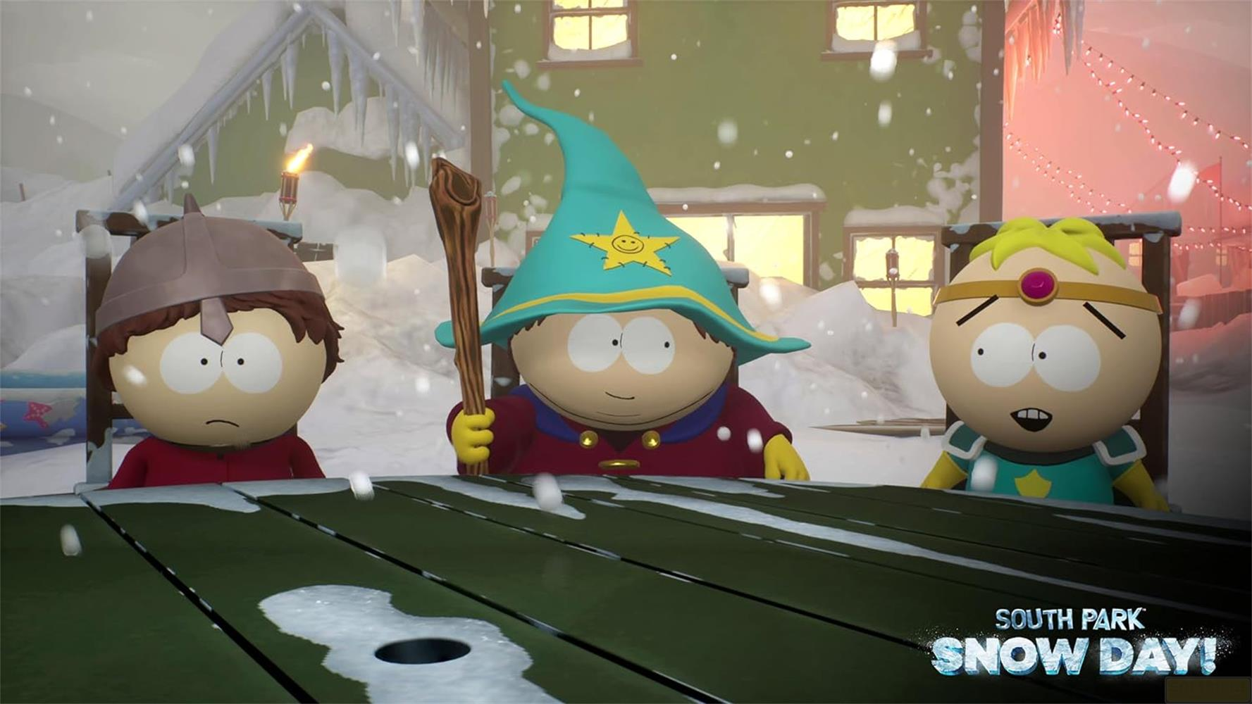 Trois personnages de South Park costumés sont assis à une table enneigée.