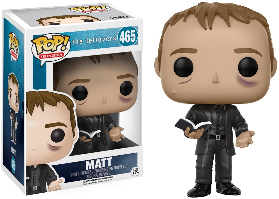 Funko Pop Vinylfigur von Matt aus The Leftovers in einem schwarzen Anzug mit Buch, neben der Verpackung.