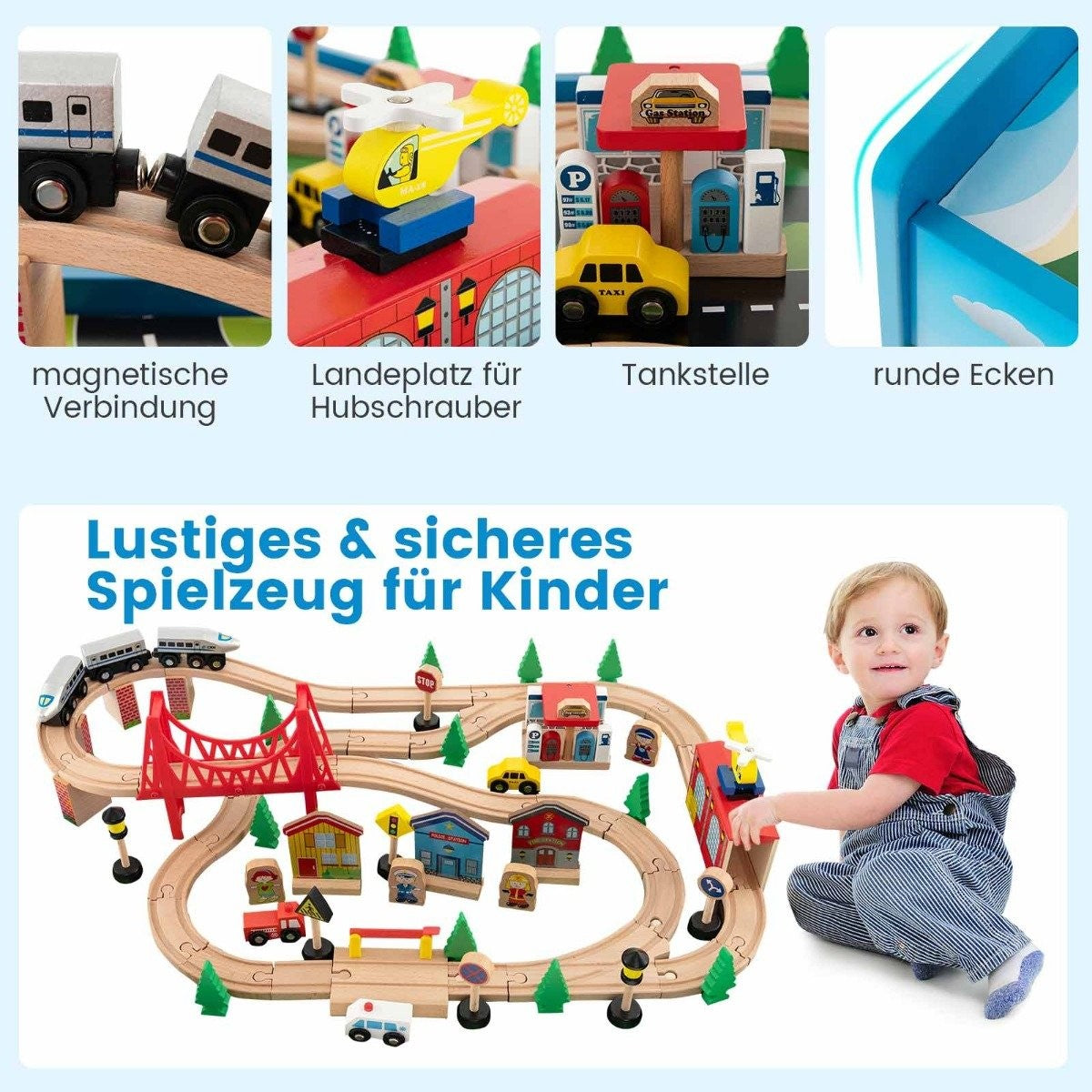 Un tout-petit joue avec un grand train en bois comprenant des rails, des ponts, des bâtiments, des voitures et un hélicoptère.