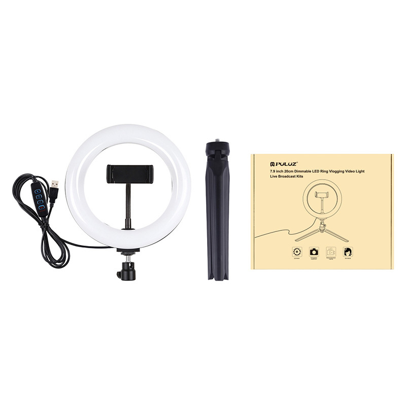 Una luce ad anello LED con treppiede e scatola su sfondo bianco.