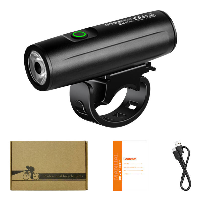 Luce per bicicletta nera con supporto, scatola piccola, manuale e cavo di ricarica USB su sfondo bianco.