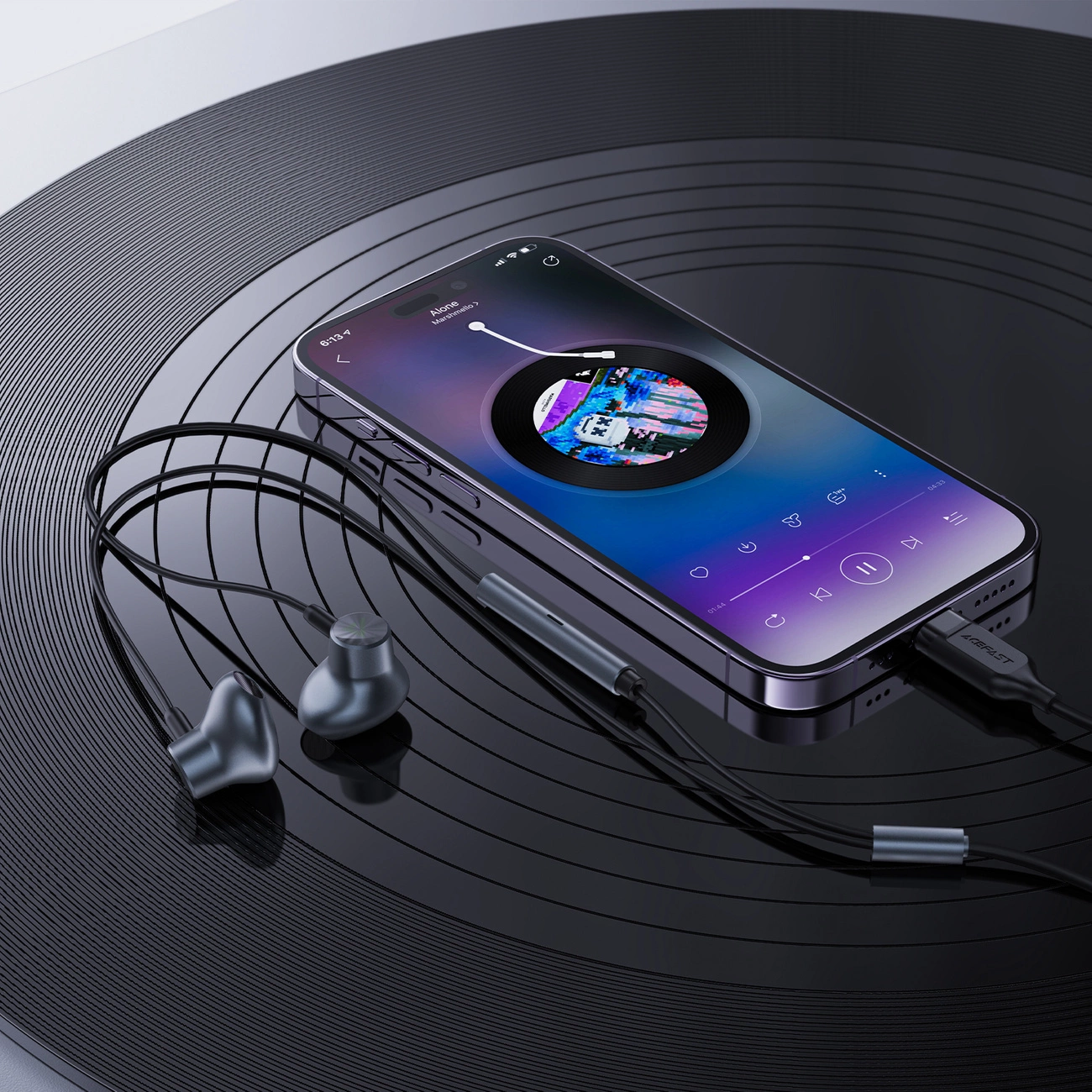 Uno smartphone che riproduce musica poggia su un disco in vinile nero, collegato a cuffie cablate.