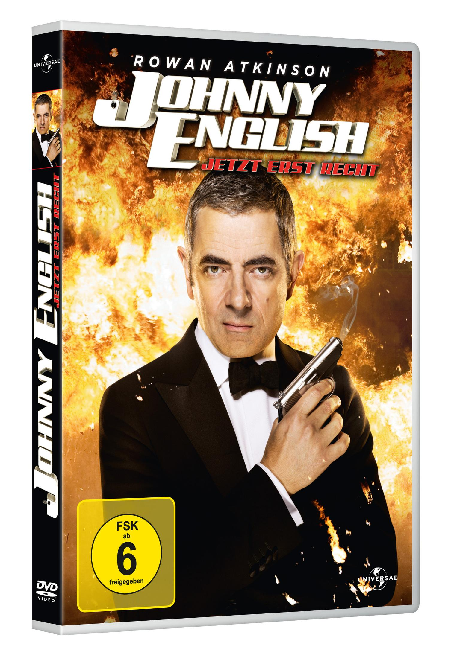 Johnny English DVD-Cover mit Rowan Atkinson in Smoking vor einer Explosion mit Waffe.
