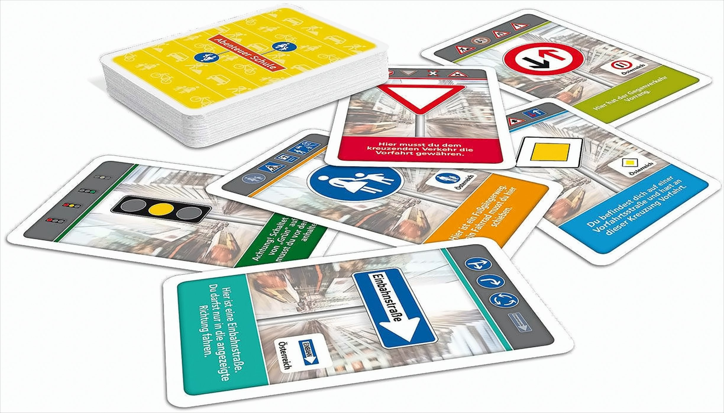 Ein Stapel und lose Spielkarten mit deutschen Verkehrsschildern auf weißem Hintergrund.