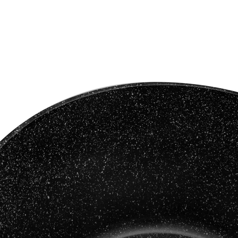 Primer plano del interior de una olla negra con motas sobre fondo blanco.