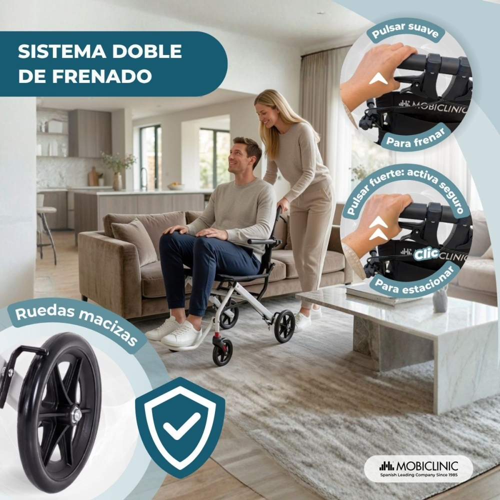Una mujer empuja a un hombre en una silla de ruedas ligera en un salón, con detalles de ruedas y frenos.