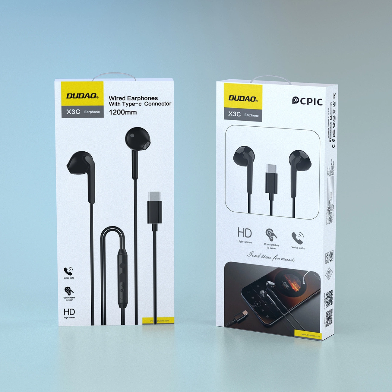 Due scatole bianche di auricolari USB-C Dudao X3C sono affiancate su un tavolo azzurro.