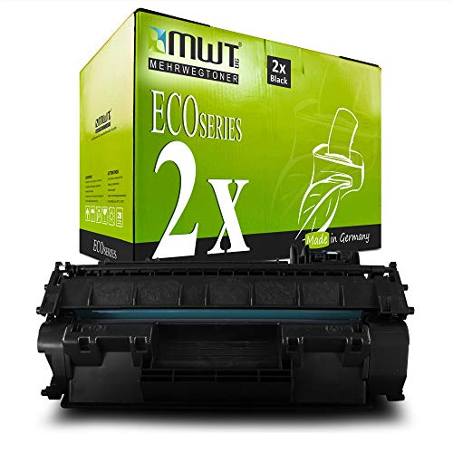 Eine grüne MWT Eco Series Tonerkartuschenbox mit zwei schwarzen Patronen, davor liegt eine schwarze Tonerkartusche.