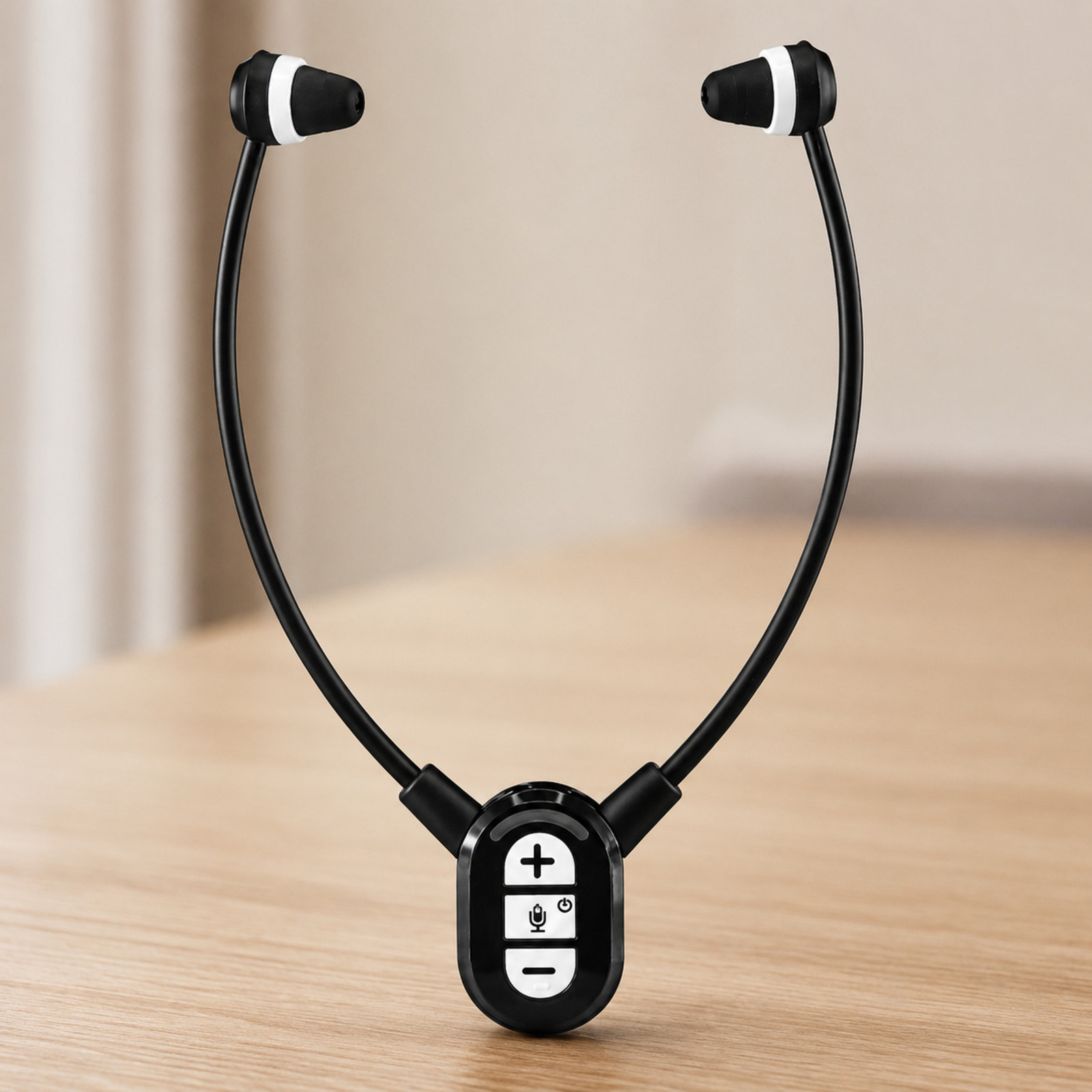 Auricolari da collo neri con pannello di controllo bianco su tavolo.
