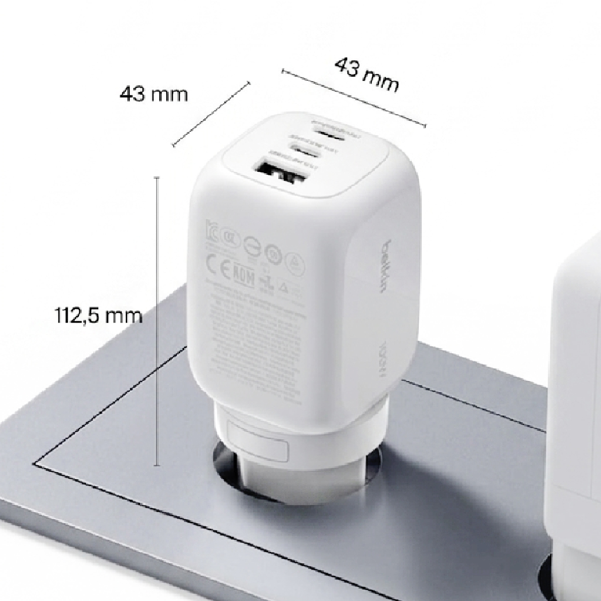 White USB charger plugged in with dimensions: 43x43 mm and 112.5 mm height.