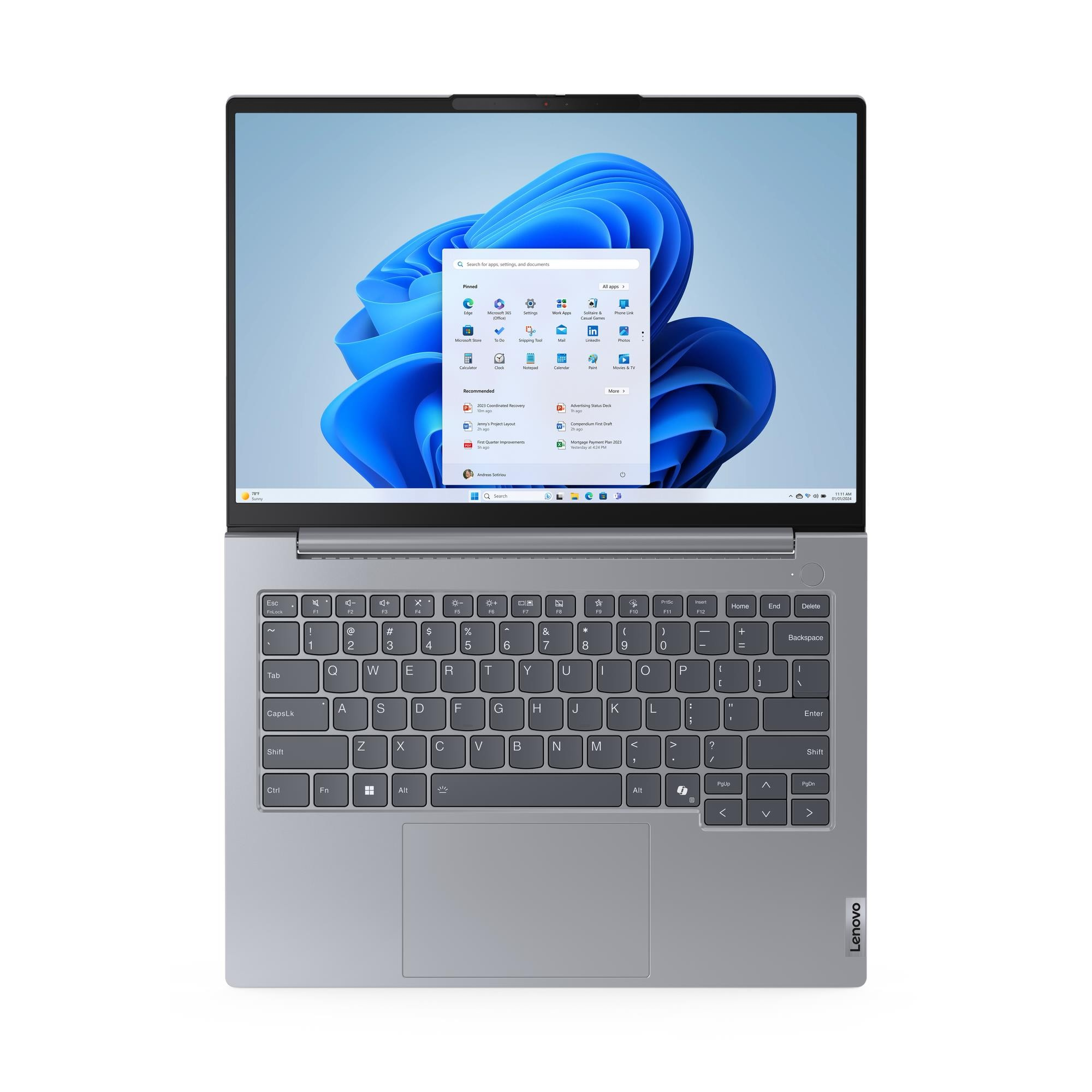 Siyah klavyeli gri bir dizüstü bilgisayar, mavi Windows 11 başlangıç ekranını gösteriyor.