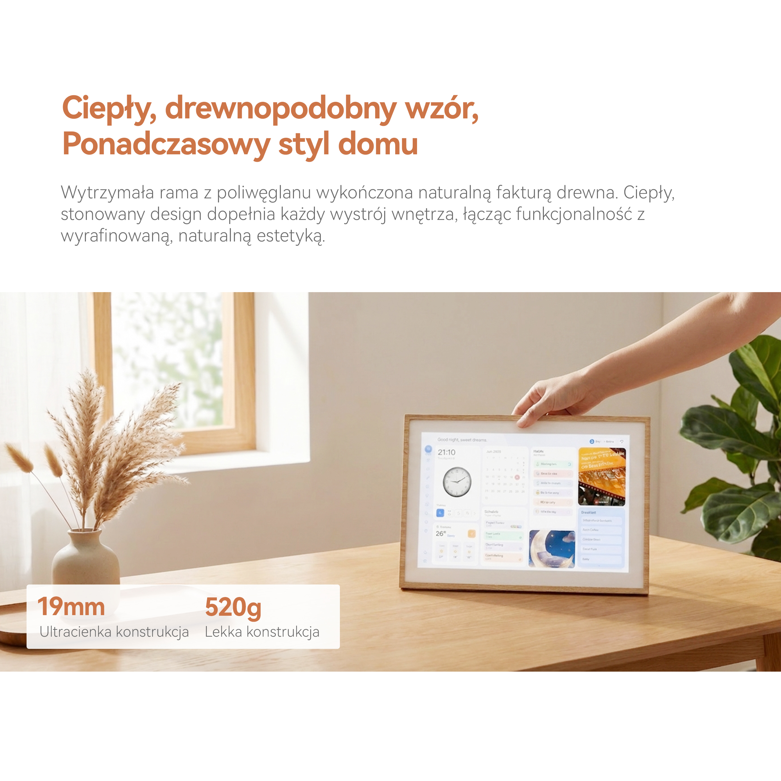 Ręka stawia cyfrową ramkę w drewnianej oprawie na drewnianym stole.