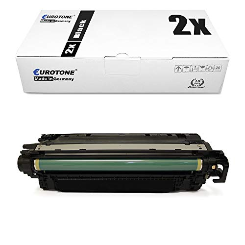 Eine schwarze Drucker-Tonerkassette mit grüner Walze vor einer weißen Verpackungsbox.