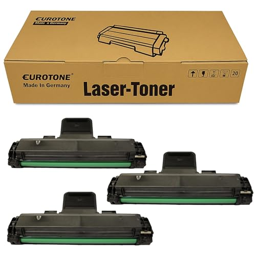 Eine Eurotone Laser-Toner Box und drei schwarze Tonerkartuschen mit grünen Rollen auf weißem Hintergrund.
