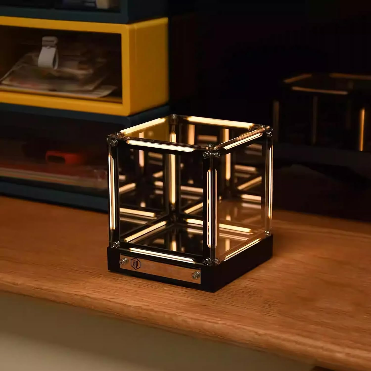 Ein beleuchteter, quadratischer Schrein mit goldenem Neonlicht steht auf einem Holztisch.