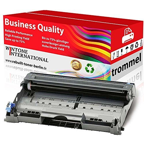 Eine graue Trommeleinheit für Drucker vor einer rot-weißen Verpackungsbox mit buntem Wellenmuster.