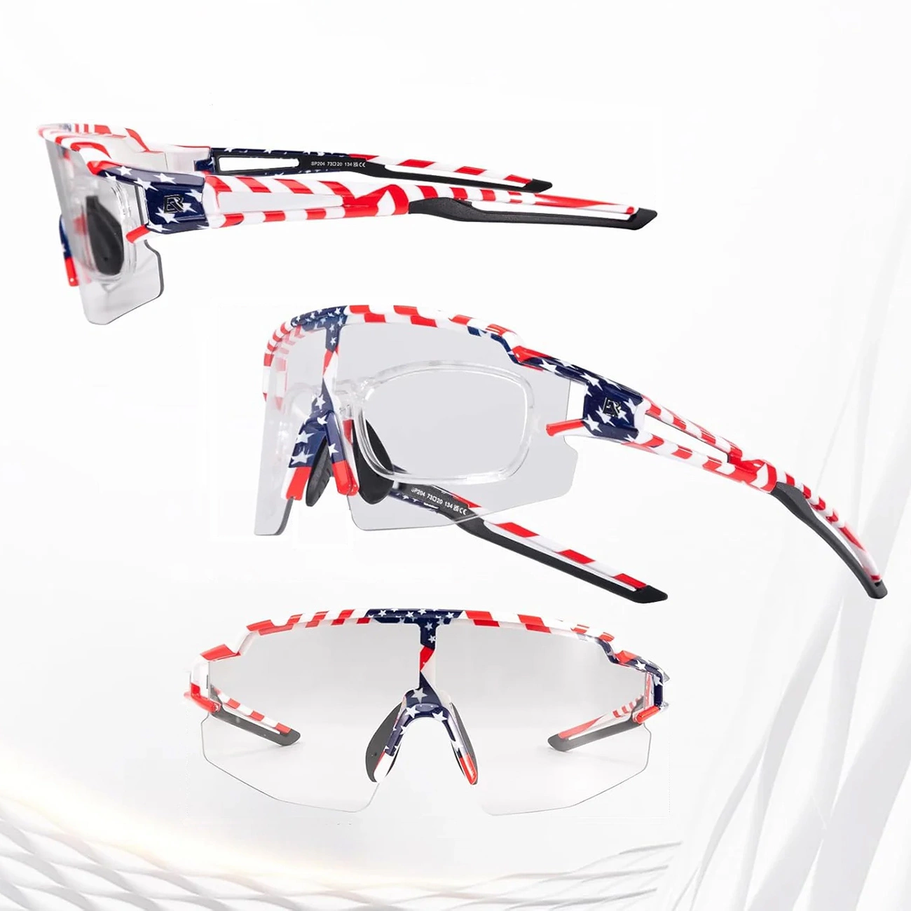 Tre viste di occhiali da sole sportivi con design della bandiera USA, lenti trasparenti e montatura rossa, bianca e blu.
