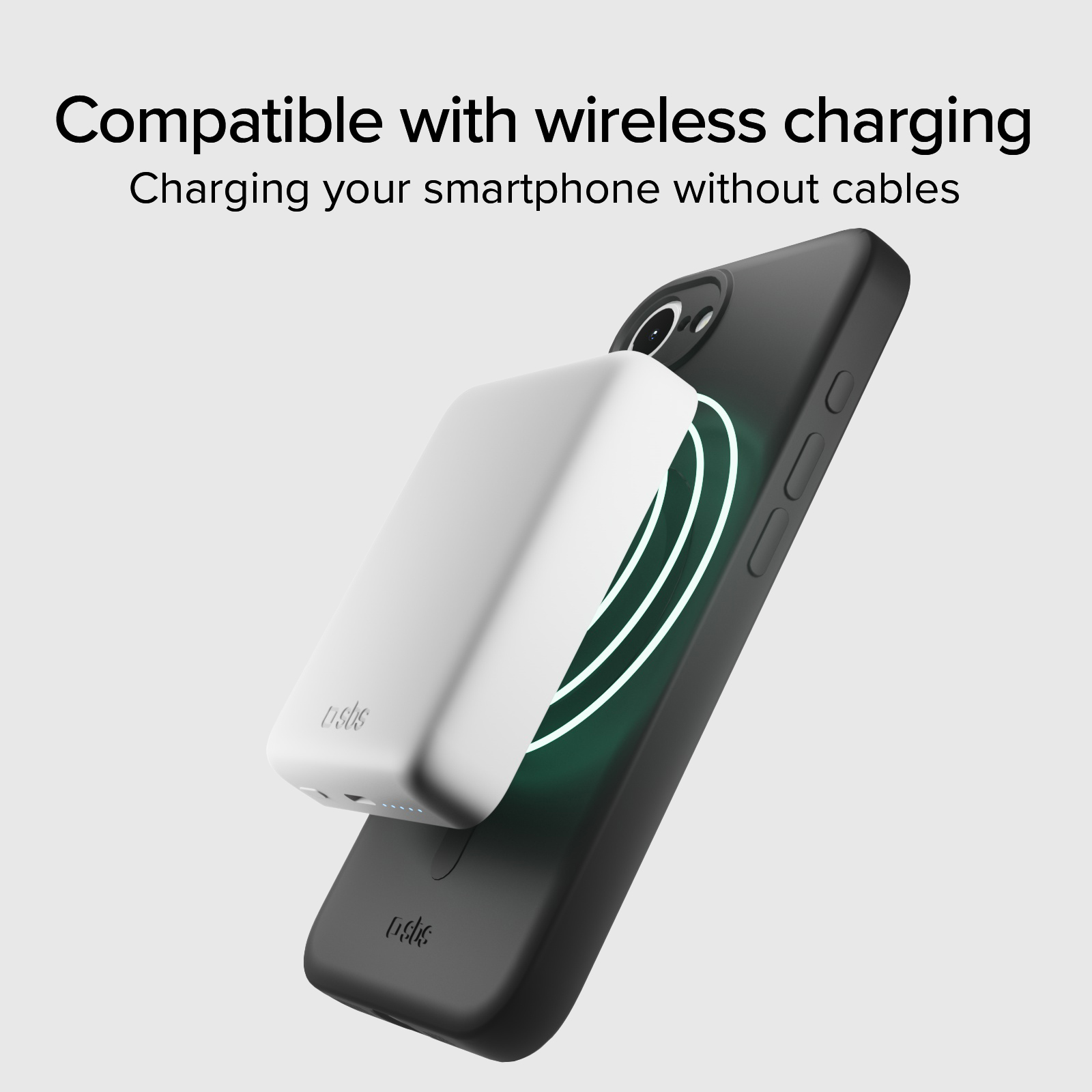 Una batería portátil inalámbrica blanca está adherida a la parte trasera de un teléfono negro.